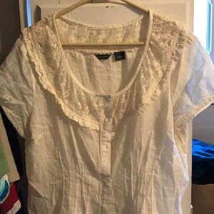 Short sleeved pin tucked cream blouse.